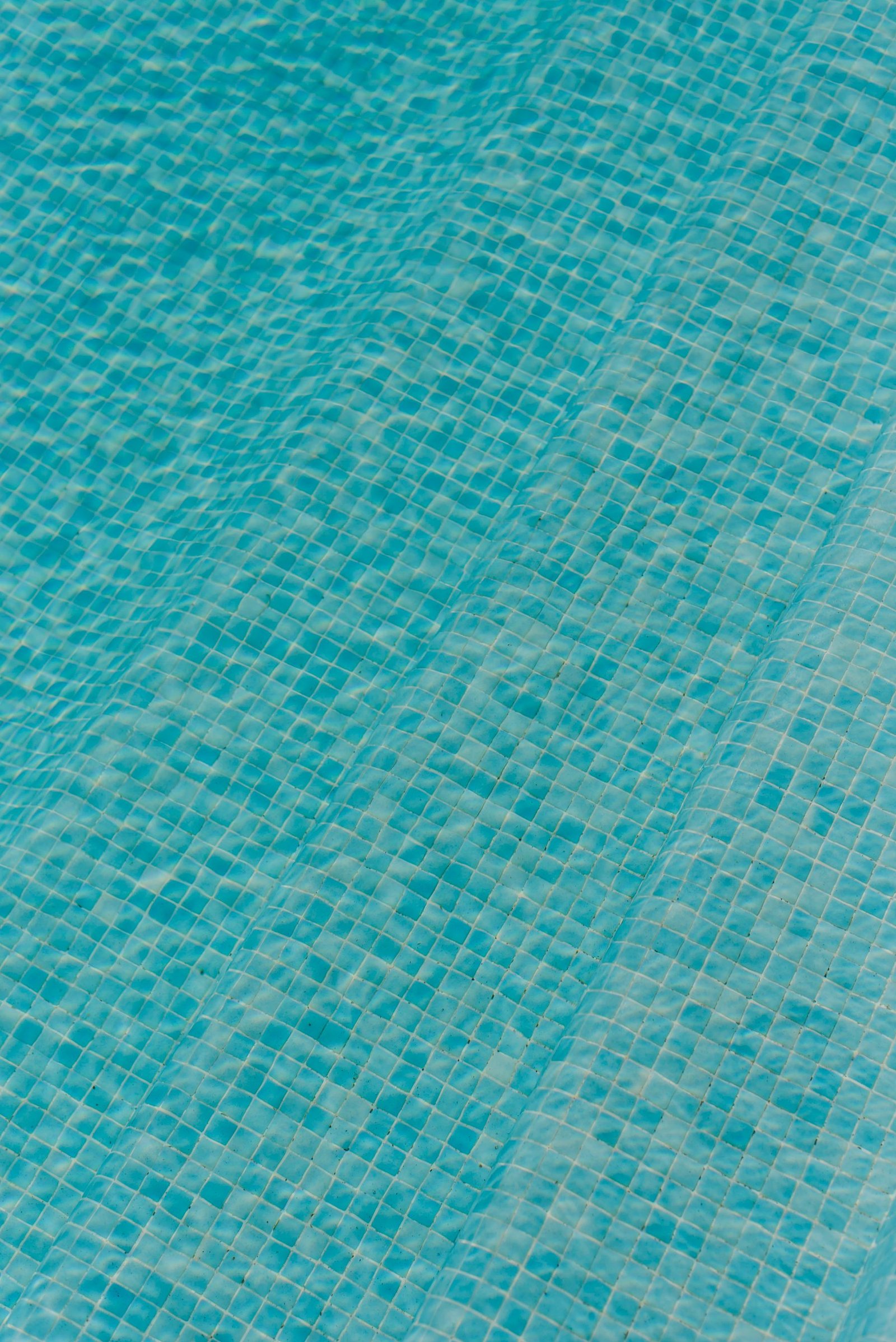 Blue swimming pool mosaic beneath water